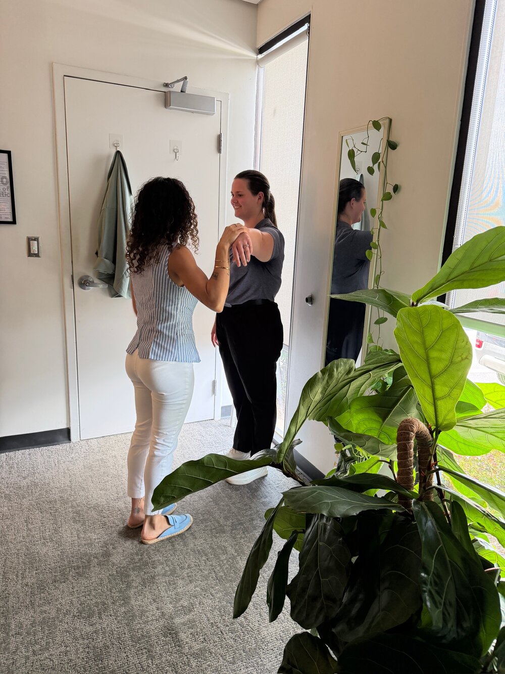Muscle testing during NET session at WholeCare Wellness Collective Marietta